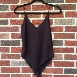 NEVER USED- black bodysuit with thin straps. Considered juniors (small)